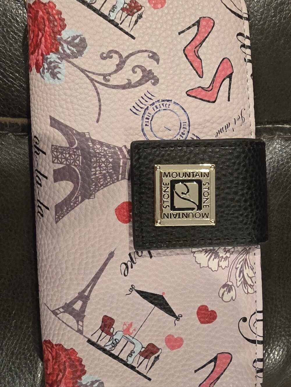 Stone Mountain wristlet features a black snap closure and a colorful, Paris-them